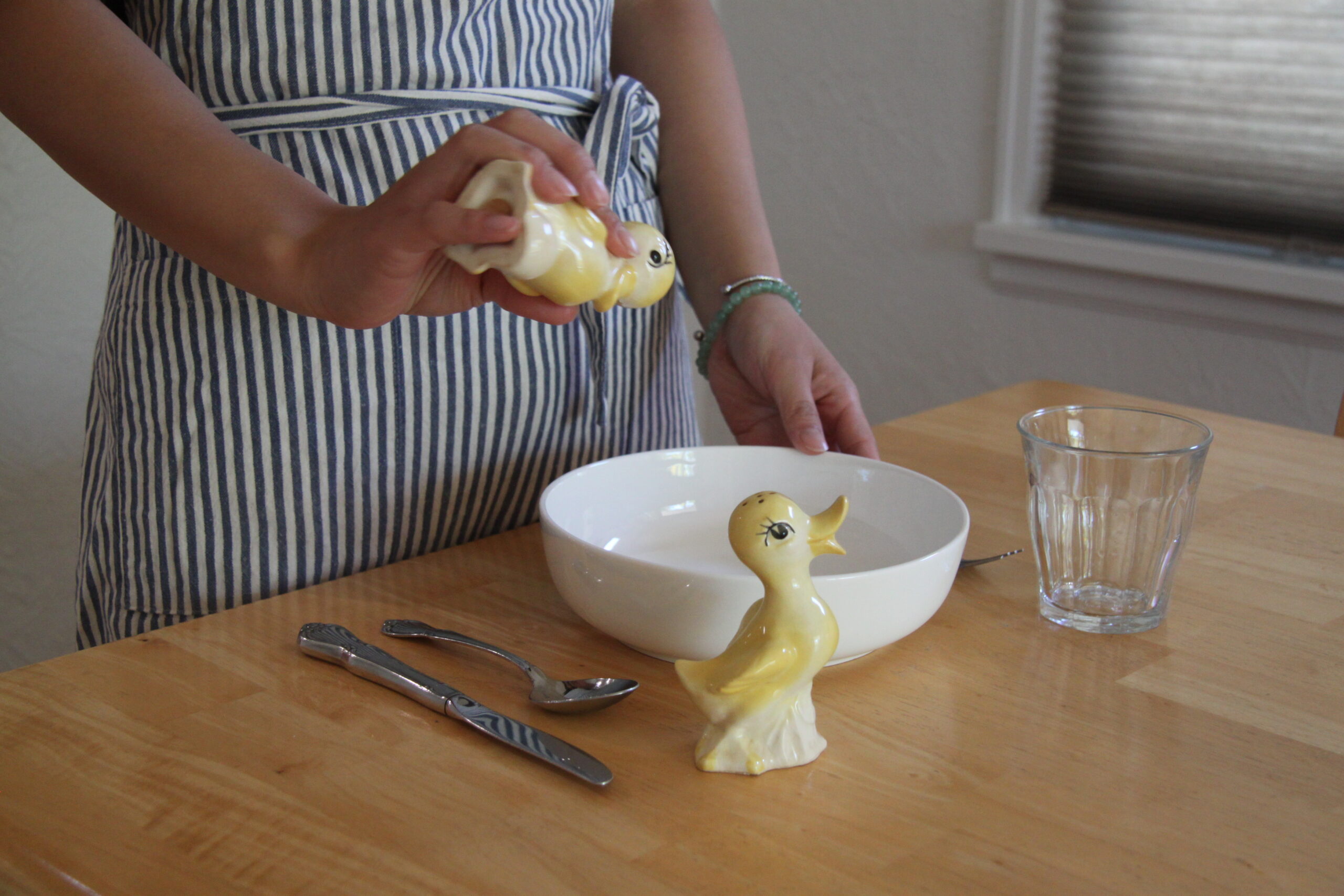 Before edits. Shaking duck salt shaker into empty bowl.